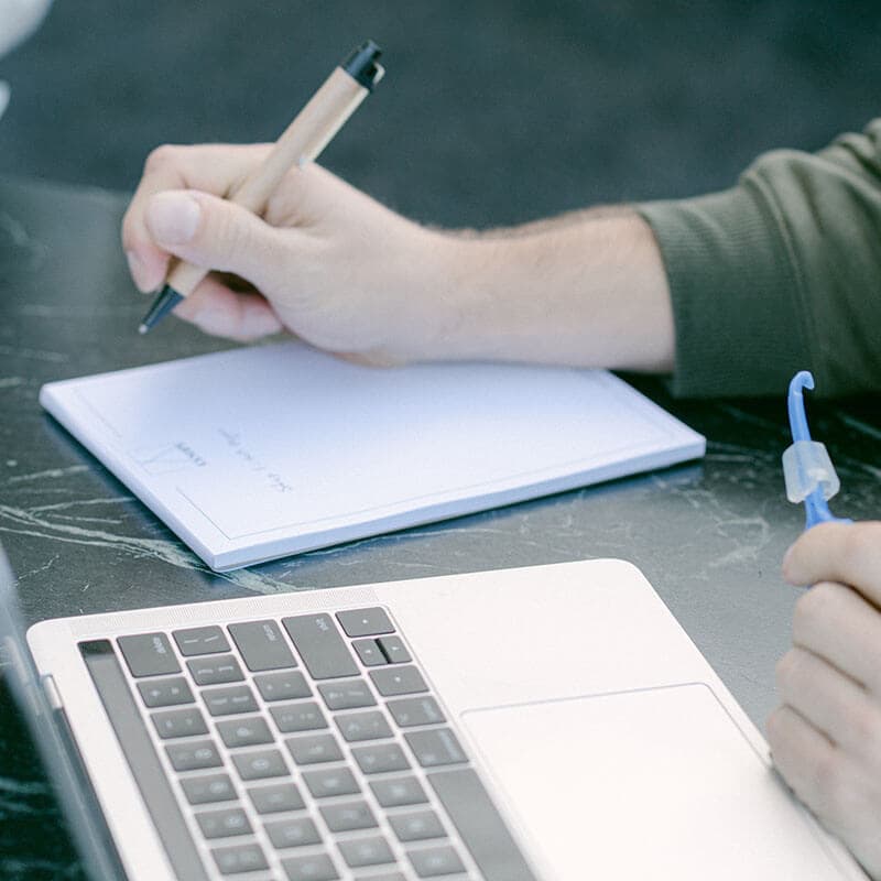 Notes being written by hand while working through a business strategy